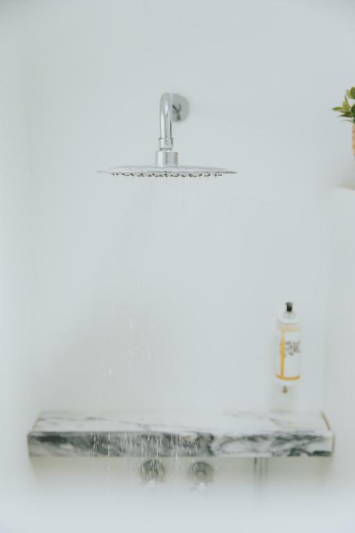 a glass shelf with two bottles on it at Senhora do Cabo Meco Homy Holidays in Sesimbra