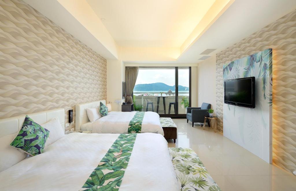 Cette chambre comprend 2 lits et une télévision à écran plat. dans l'établissement Hu Yue Lakeview Hotel, à Yuchi
