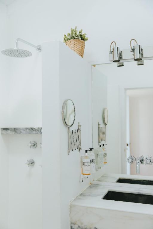 a bathroom with white walls and a sink at Senhora do Cabo Meco Homy Holidays in Sesimbra