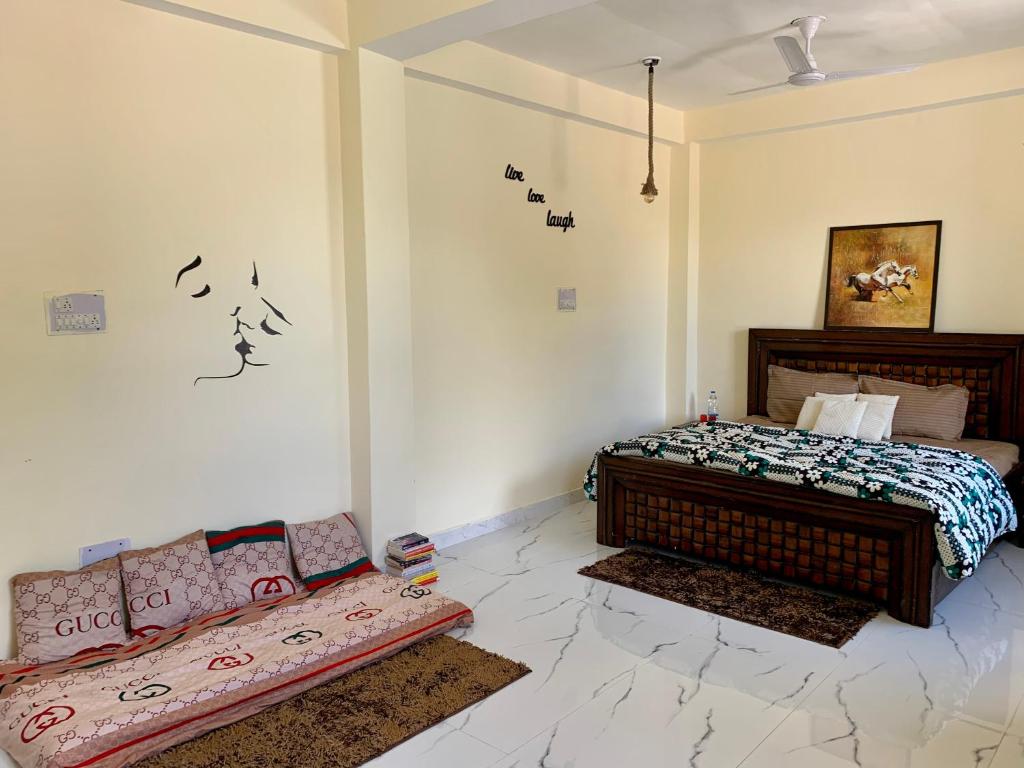 a bedroom with a bed and a couch in it at OTW Guest House & Mountain Cafe in Kasol