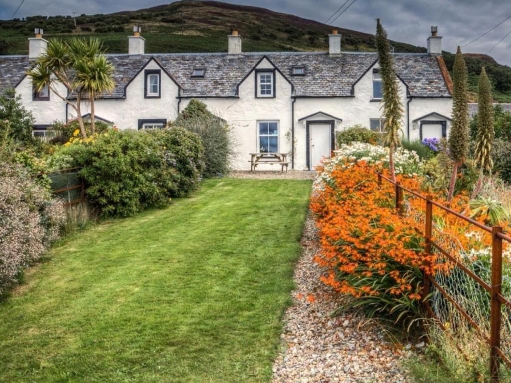 a house with a garden in front of it at The Apostles in Catacol