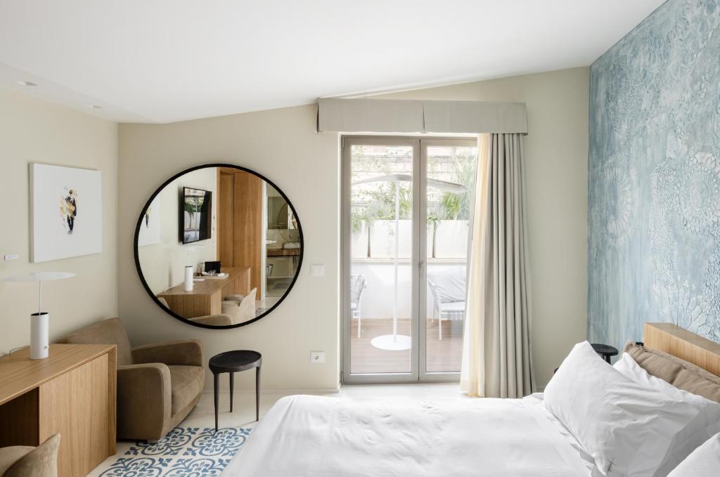 A bed or beds in a room at Ognissanti Restaurant Spa Hotel Rooftop