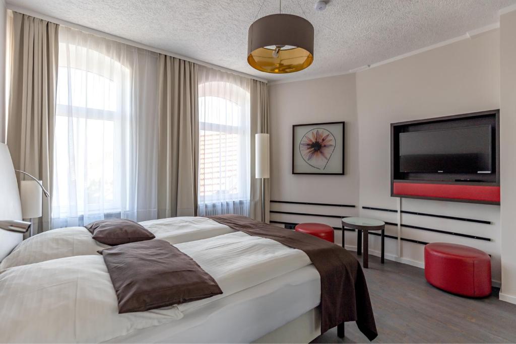 Postel nebo postele na pokoji v ubytování Hotel Garni " Am Domplatz"