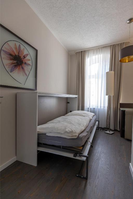 Postel nebo postele na pokoji v ubytování Hotel Garni " Am Domplatz"