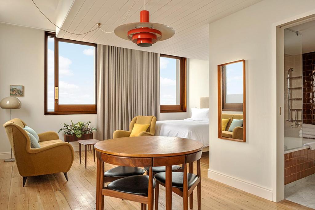 a hotel room with a table and chairs and a bed at Fort Road Hotel in Margate