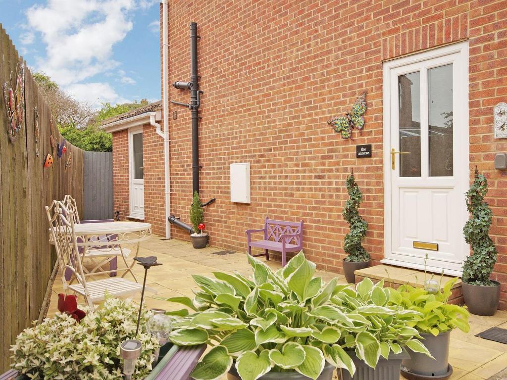 a patio with potted plants and a brick building at The Annexe in Knaresborough