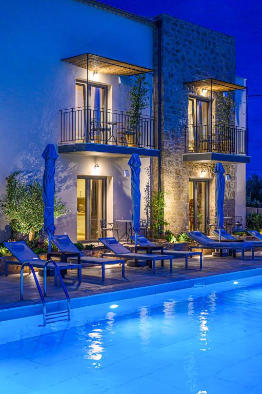 a villa with a swimming pool at night at Kannas Mani Luxury Suites -Adults Friendly 14 Plus in Stoupa