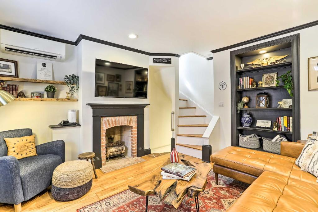 a living room with a couch and a fireplace at Historic Home with Garden Walk to Center City! in Philadelphia
