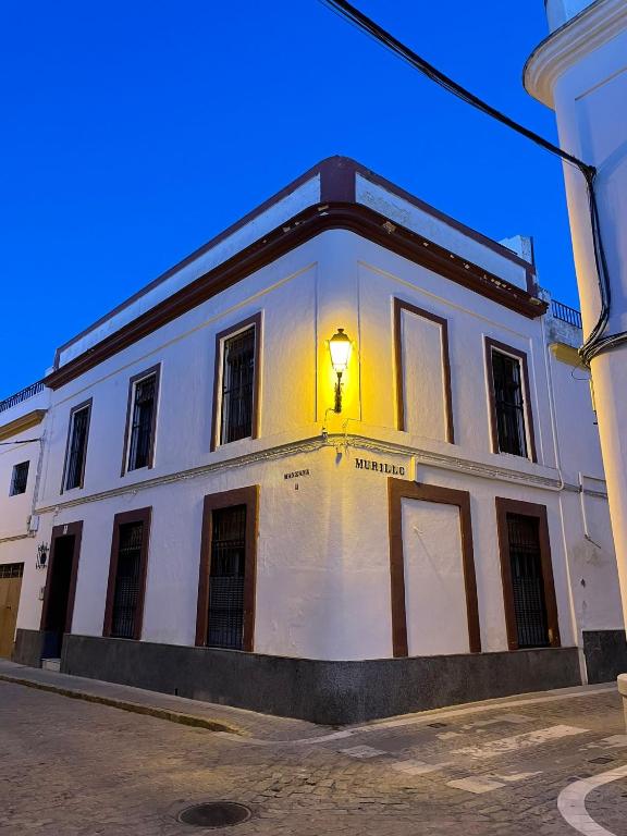 um edifício branco com uma luz na lateral em Casa Los pinceles de Murillo em Lora del Río