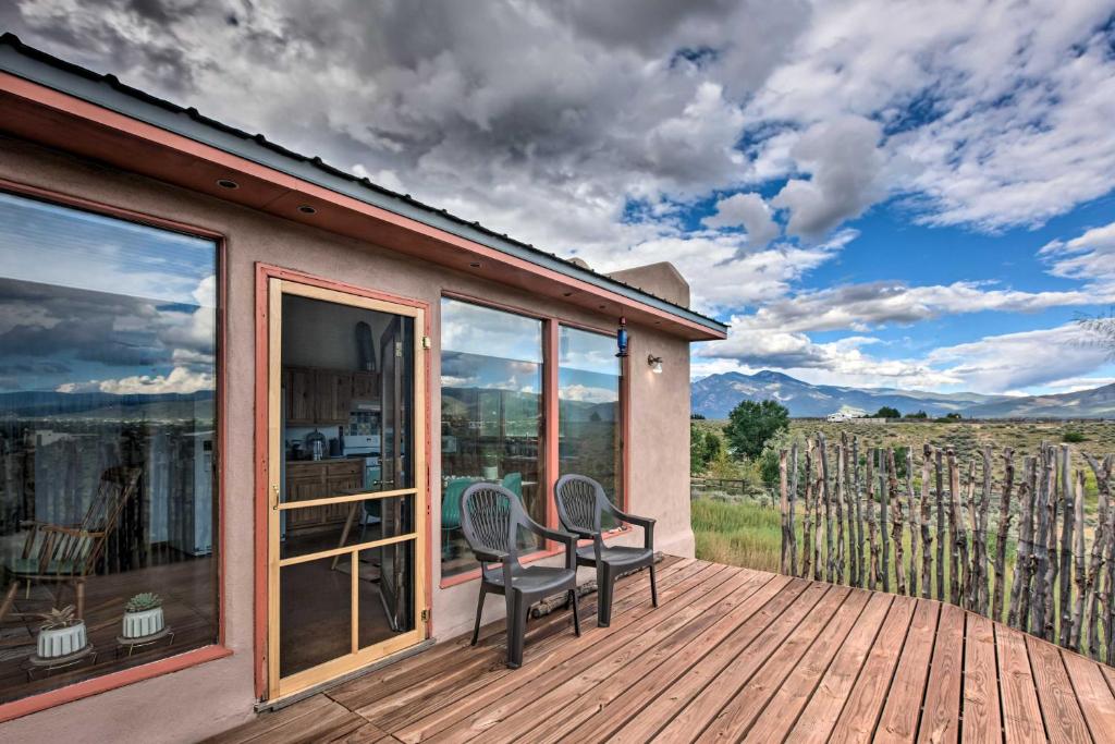 a patio with two chairs on a wooden deck at El Prado Duplex with Deck and Grill - 4 Mi to Town! in El Prado