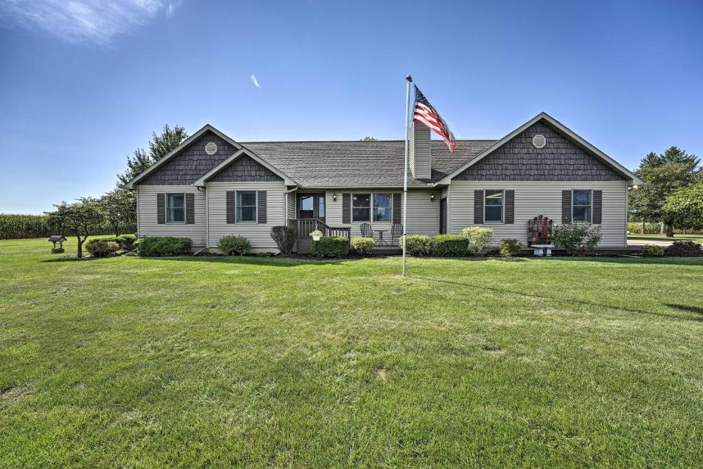 a house with an american flag in the yard at Welcoming Sturgis Getaway with Spacious Yard! in Sturgis