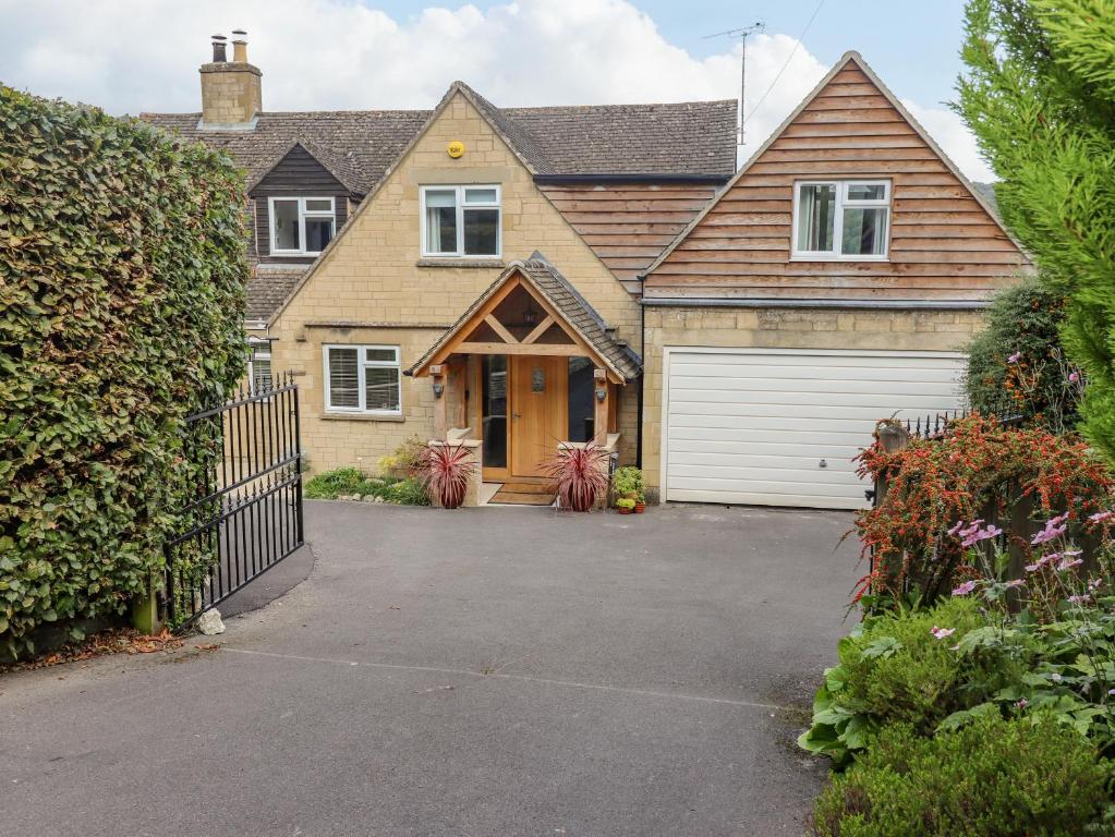 a house with a garage and a driveway at The Gables in Stroud