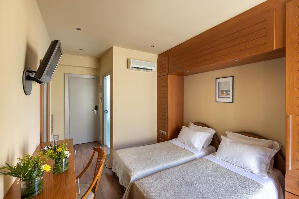 Postel nebo postele na pokoji v ubytování Hotel Palladion