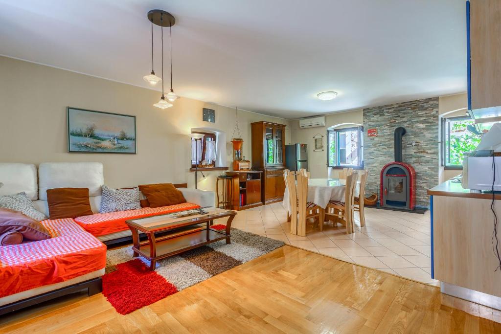 a living room with a couch and a table at Old stone house St Lawrence in the heart of Sibenik's old town in Šibenik