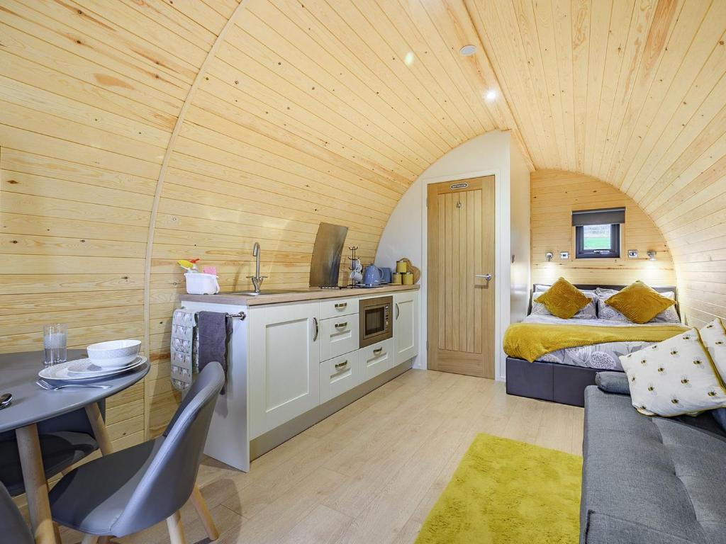 a bedroom with a bed and a kitchen with a table at Coton - Ukc5324 in East Haddon