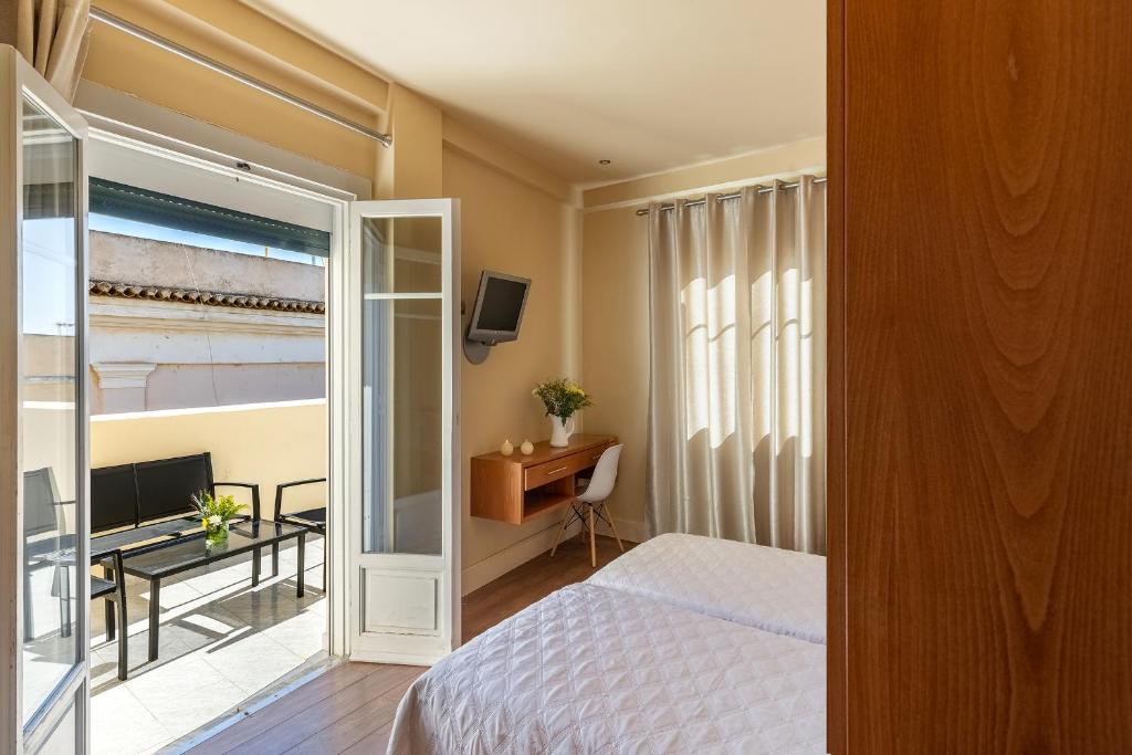 Postel nebo postele na pokoji v ubytování Hotel Palladion