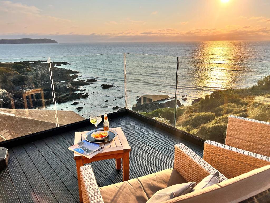 a balcony with a table and a view of the ocean at Watersmeet Hotel in Woolacombe