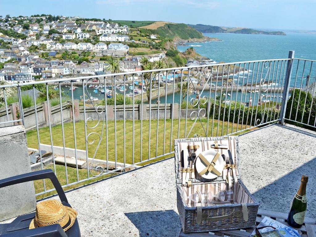 a balcony with a view of a harbor and the ocean at Berlewen - Ukc3536 in Mevagissey