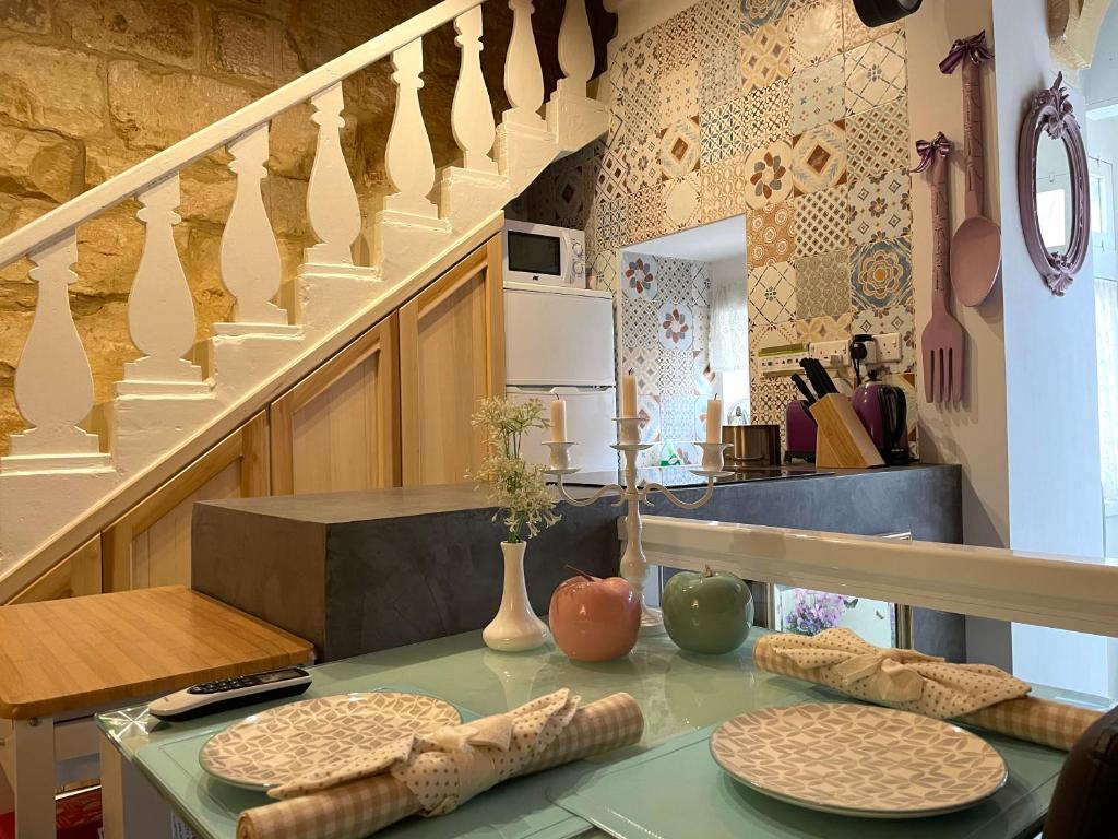 a kitchen with a table with plates on it at Moi in Birkirkara