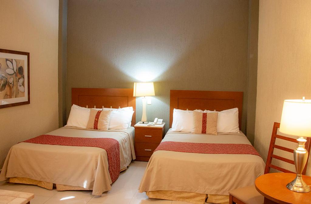 Postel nebo postele na pokoji v ubytování Hotel Fenix