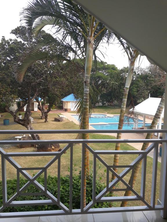 a view from the balcony of a resort with a pool at CARIBBEAN POOL-SIDE VILLA 1148 in Port Edward