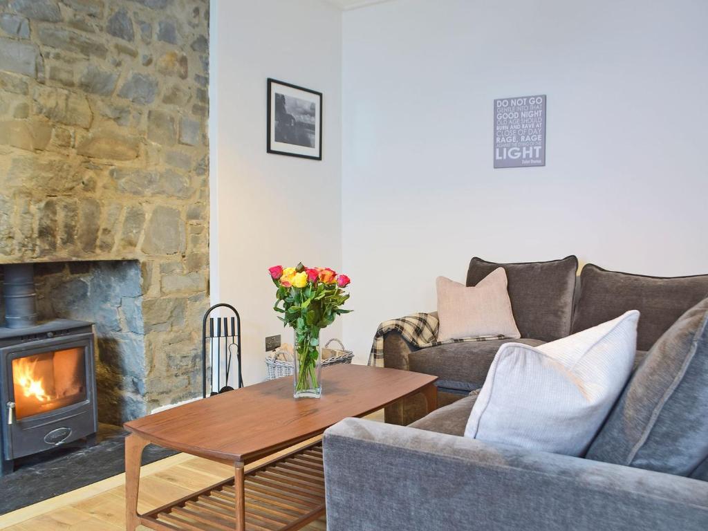 a living room with a couch and a fireplace at Bristol House in New Quay