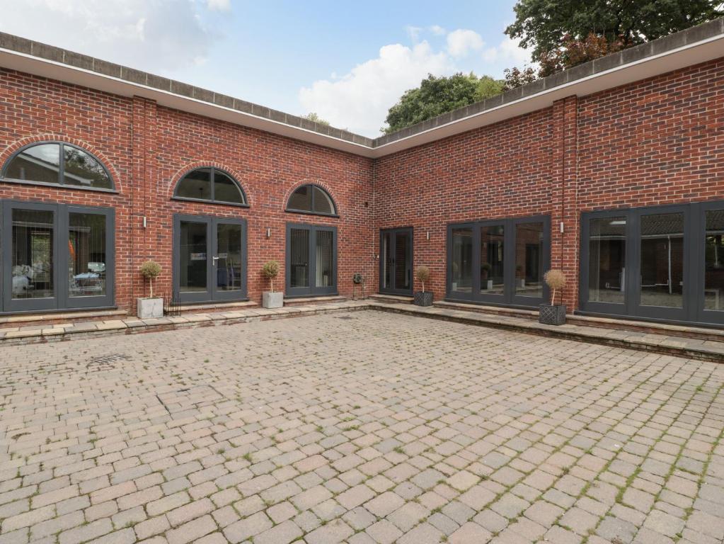 an empty courtyard of a brick building at The Annex in Wimborne Minster