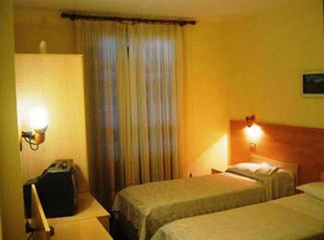 Postel nebo postele na pokoji v ubytování Hotel Quo Vadis