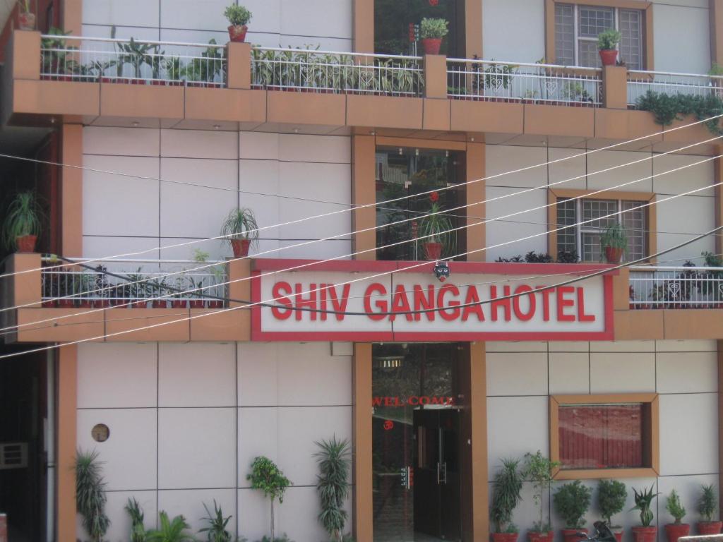a building with a sign on the side of it at Hotel Shiv Ganga in Rishīkesh