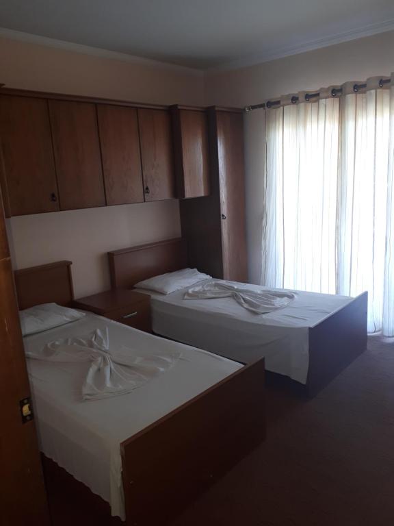 a room with two beds and a window at Hotel Meteor in Shkodër