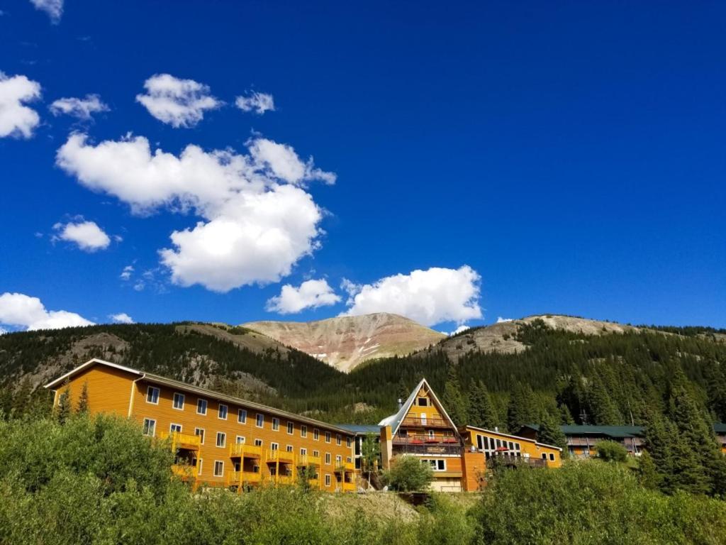 a building in front of a mountain with mountains in the background at Beautiful Views Of Mt Quandary Off Private Balcony in Breckenridge