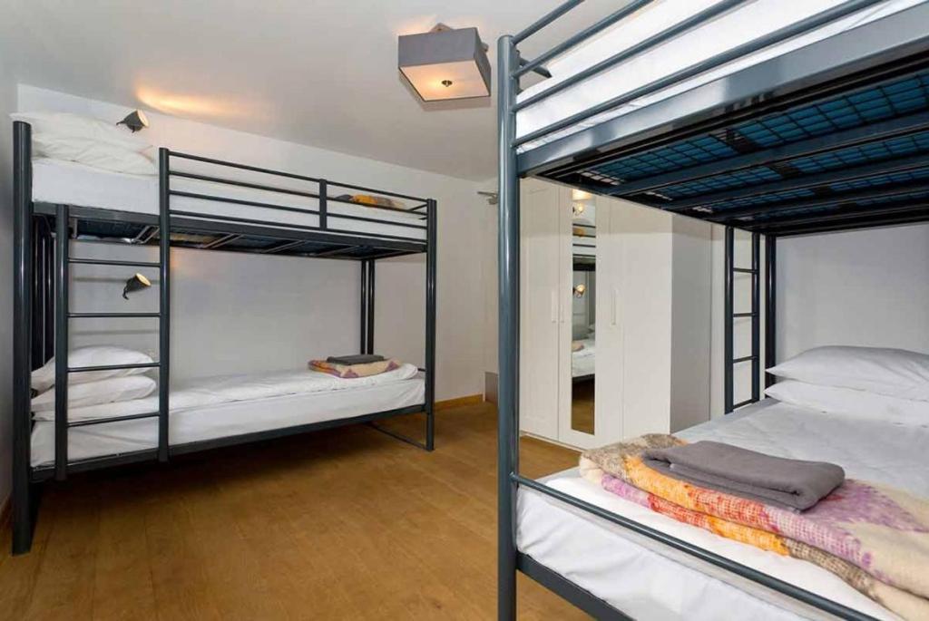 a room with two bunk beds and a room with at Bell House Hostel in London