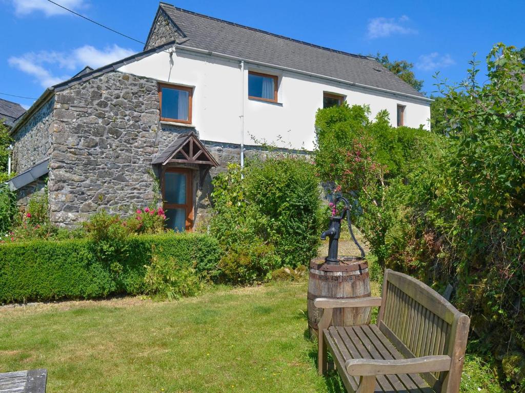 a bench sitting in front of a house at Moorview Cottage in Marytavy