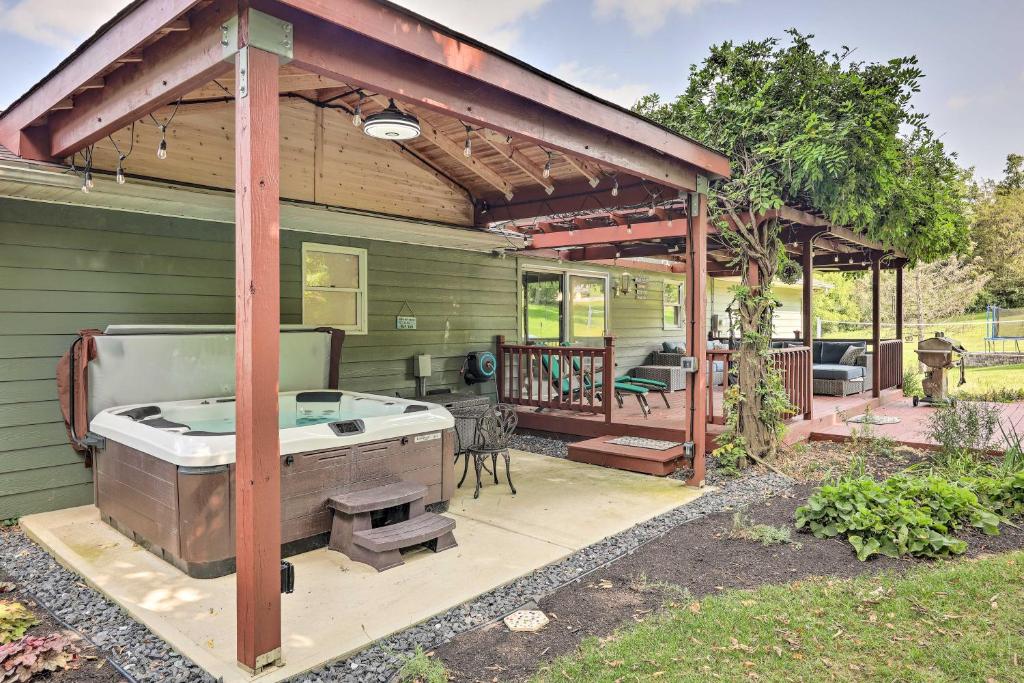 a hot tub on a patio of a house at Family-Friendly Brookville Home with Hot Tub! in Brookville