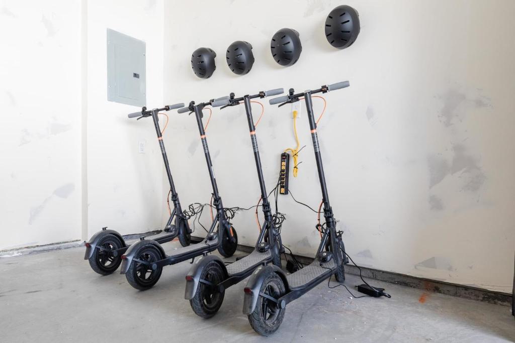 three scooters are lined up against a wall at Bear Lake Fun Close to lake Electric Scooters in Garden City