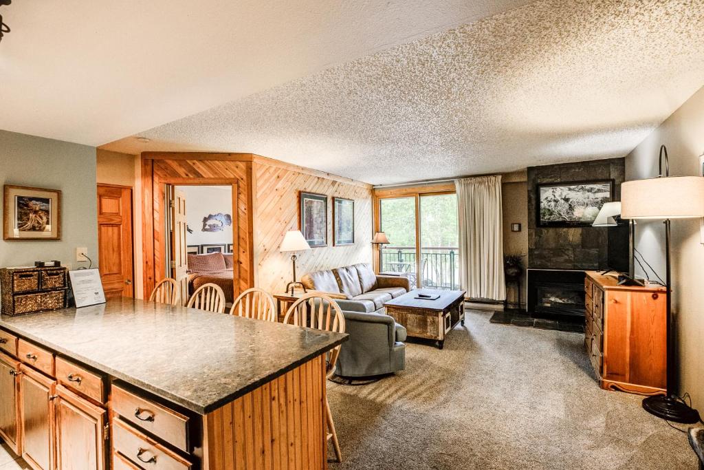 a kitchen and living room with a couch and a table at Trails End Mountain Breeze Condo - Ski In - Out - Stroll To Main Street in Breckenridge