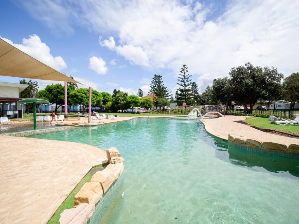 a large swimming pool in a park at Toowoon Bay Holiday Park in The Entrance