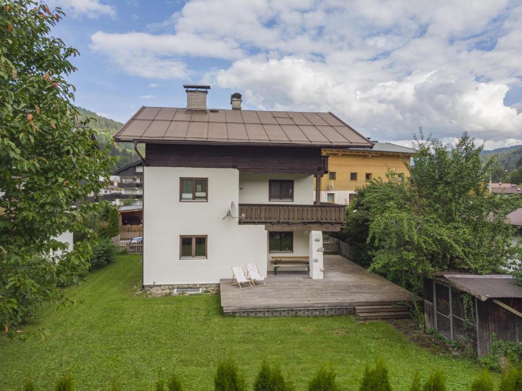 a house with a large yard with two chairs at Berg und Bach in Kirchberg in Tirol