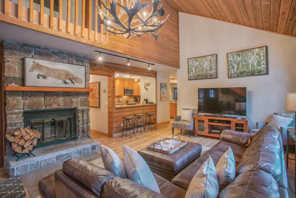 a living room with a couch and a fireplace at Aspencliffe Home: Perfect Mountain Getaway w/ Hot Tub in Blue River
