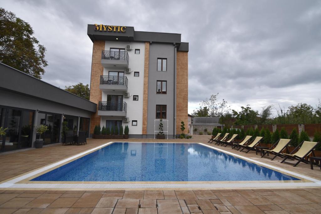 a hotel with a swimming pool in front of a building at Villa Mystic in Ohrid