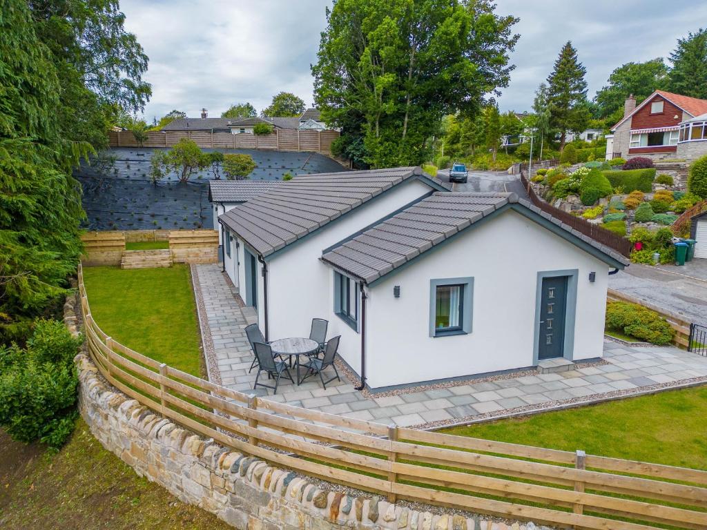 a white house with a fence around it at Heather House , luxury holiday house in Pitlochry in Pitlochry