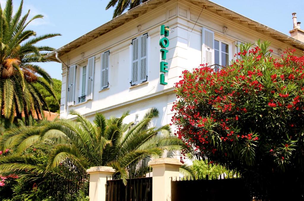 a white building with a sign on it at Hotel Villa Les Cygnes in Nice