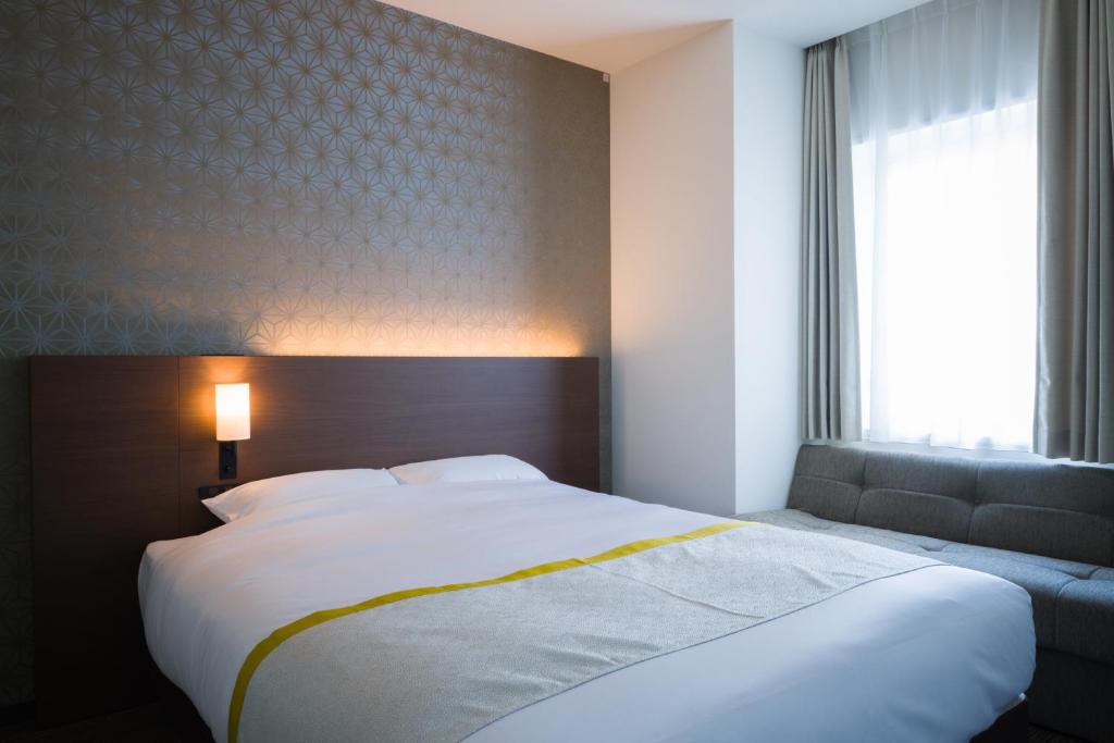 Tosei Hotel Cocone Ueno房間的床