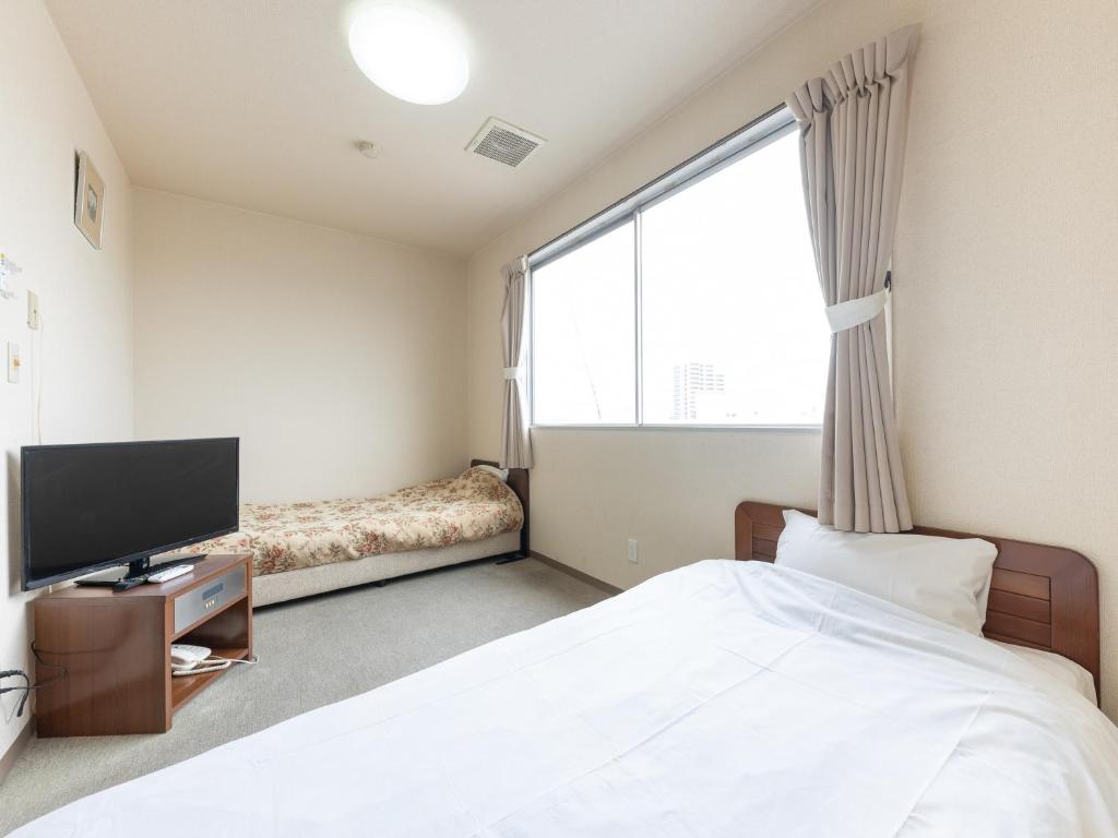TV a/nebo společenská místnost v ubytování Tabist Tatebayashi Station Hotel