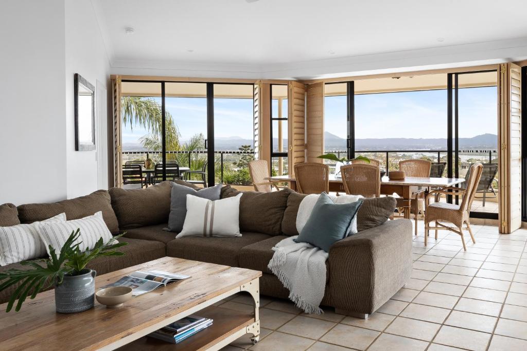 a living room with a couch and a table at Belle De Jour, Penthouse 5, Noosa Heads in Noosa Heads