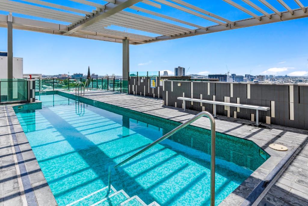 a swimming pool on the roof of a building at Quattro Apartments in Brisbane