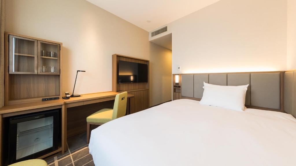 Postel nebo postele na pokoji v ubytování JR-East Hotel Mets Mejiro