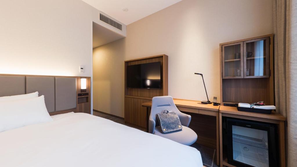 Postel nebo postele na pokoji v ubytování JR-East Hotel Mets Mejiro