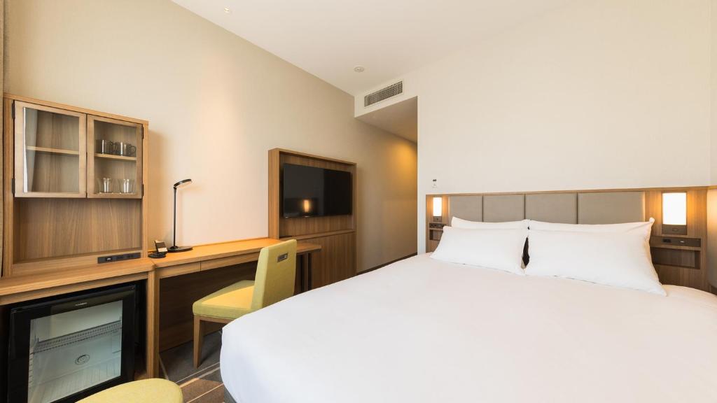 Postel nebo postele na pokoji v ubytování JR-East Hotel Mets Mejiro