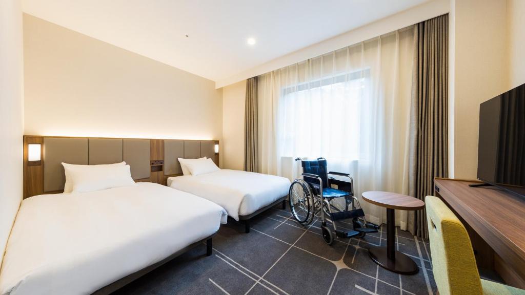 Postel nebo postele na pokoji v ubytování JR-East Hotel Mets Mejiro